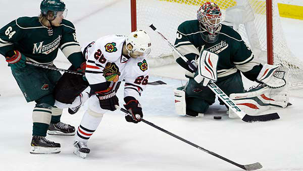Chicago Blackhawks center Michal Handzus (26), of Czech Republic, gets a shot through the legs of Minnesota Wild goalie Ilya Bryzgalov.