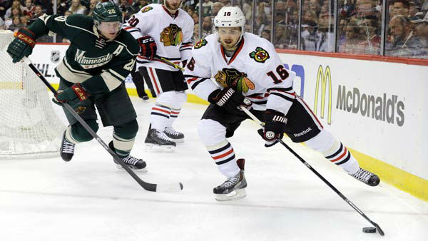 Chicago Blackhawks center Marcus Kruger (16) controls the puck in front of Minnesota Wild defenseman Ryan Sute.