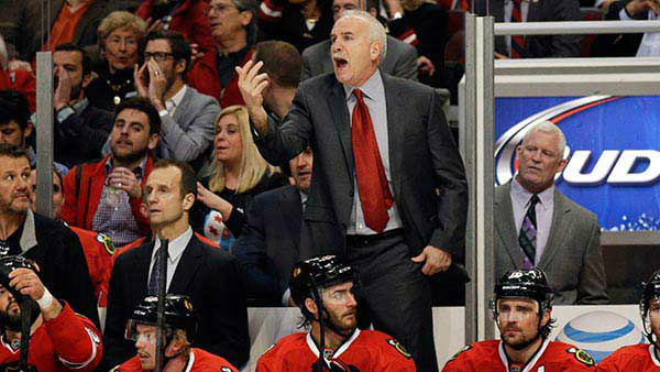 Chicago Blackhawks head coach Joel Quenneville calls to an official.