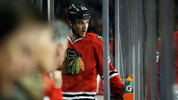 Chicago Blackhawks' Andrew Shaw (65) watches his teammates.