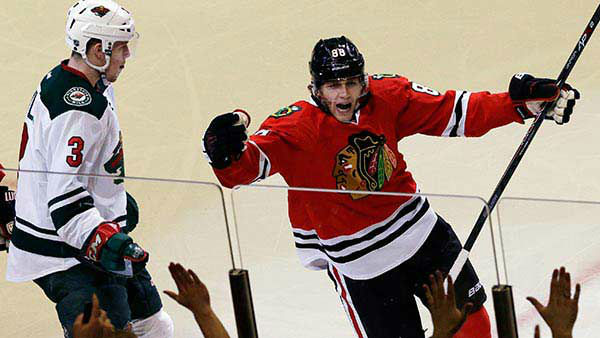 Chicago Blackhawks' Patrick Kane (88), right, celebrates after scoring during the third period in Game 1.