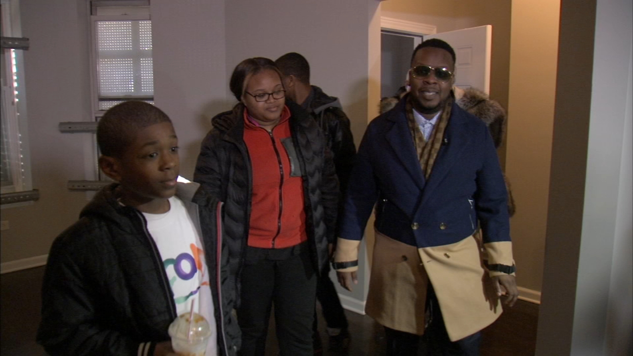 Kids of slain anti-violence activist surprised with rent-free home, new car
