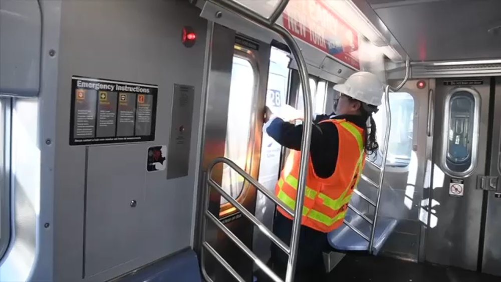 A train with doors wide open at full speed