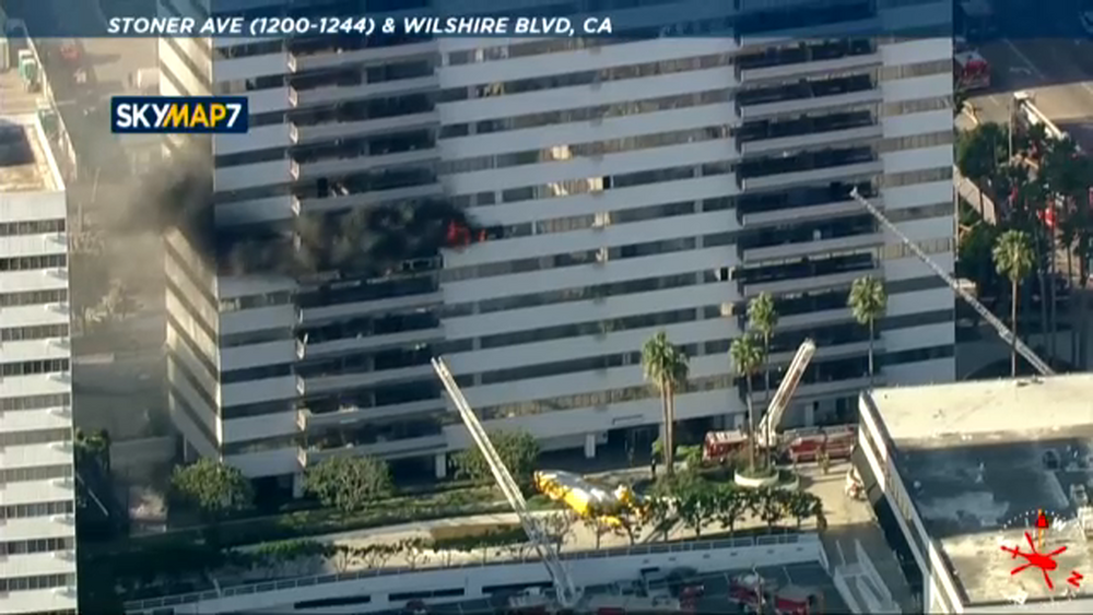 Witness describes man climbing across burning West LA high-rise apartment