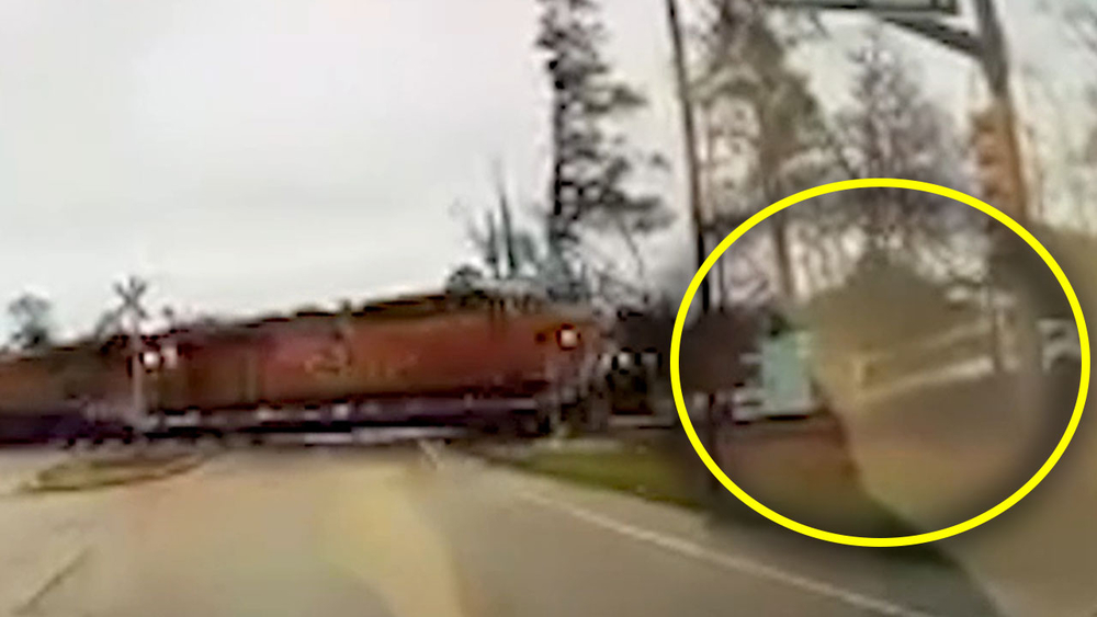 Dump truck runs red light, get hits by train on tracks in Tomball