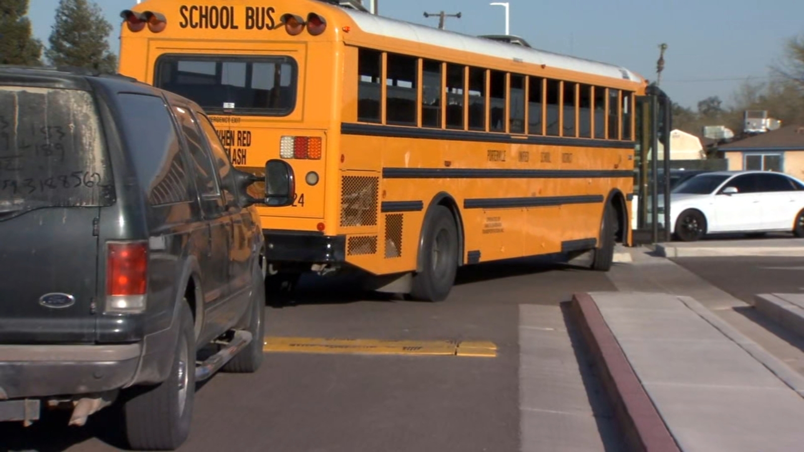 Woman pinned between school bus and car at Caruthers Elementary
