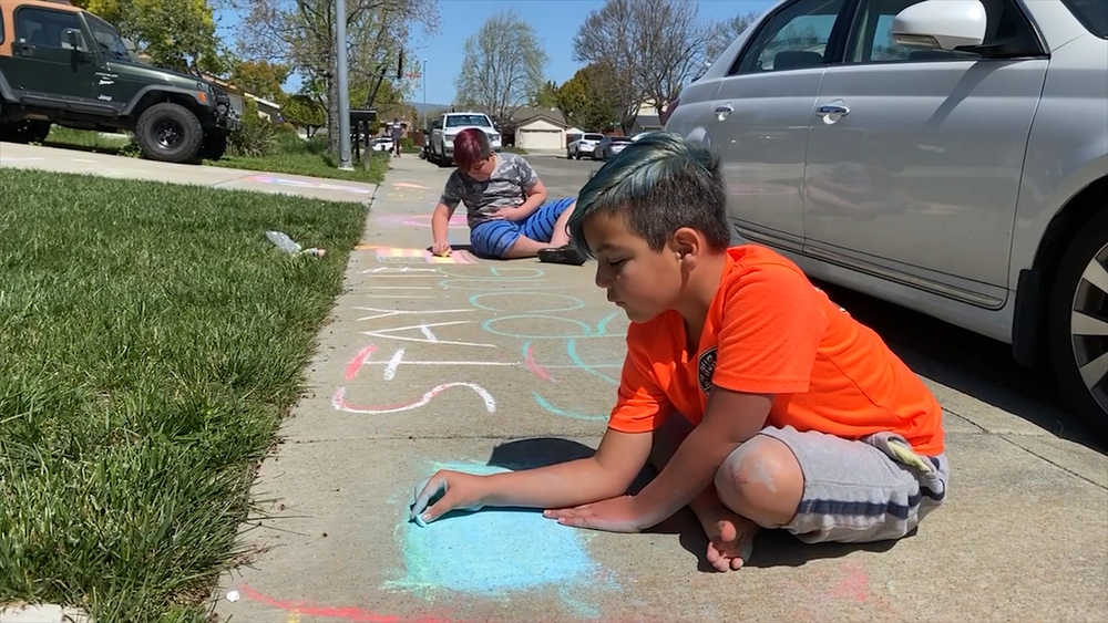Chalk art brings these neighbors together