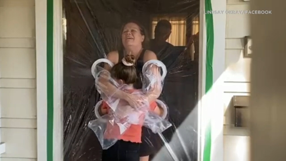 Riverside girl makes plastic curtain to be able to hug grandparents