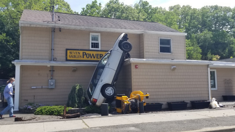 Wild crash ends with car on side of Long Island building