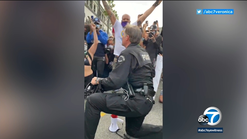 LAPD officers take a knee to show solidarity with protesters