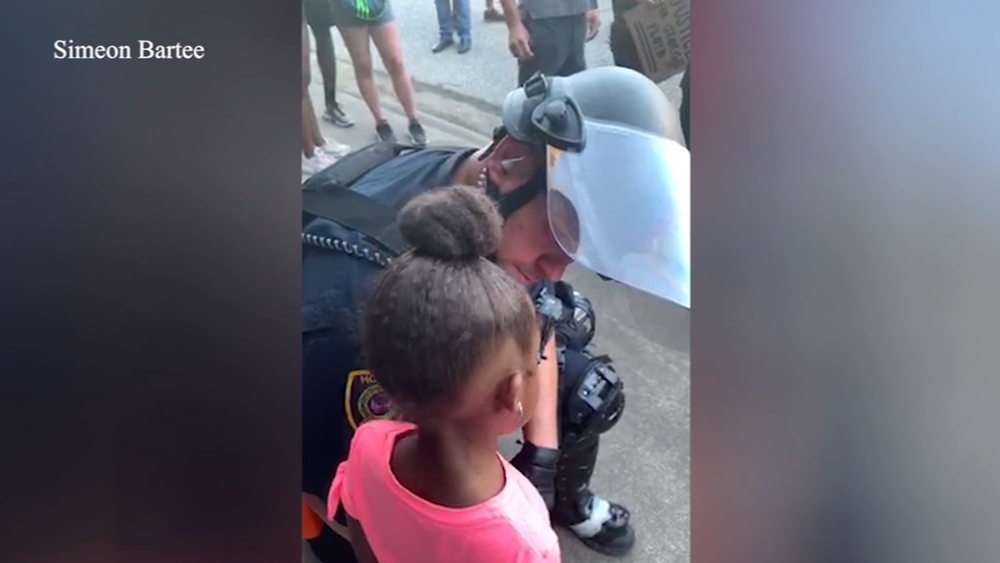 Little girl thanks HPD officer after asking tough question