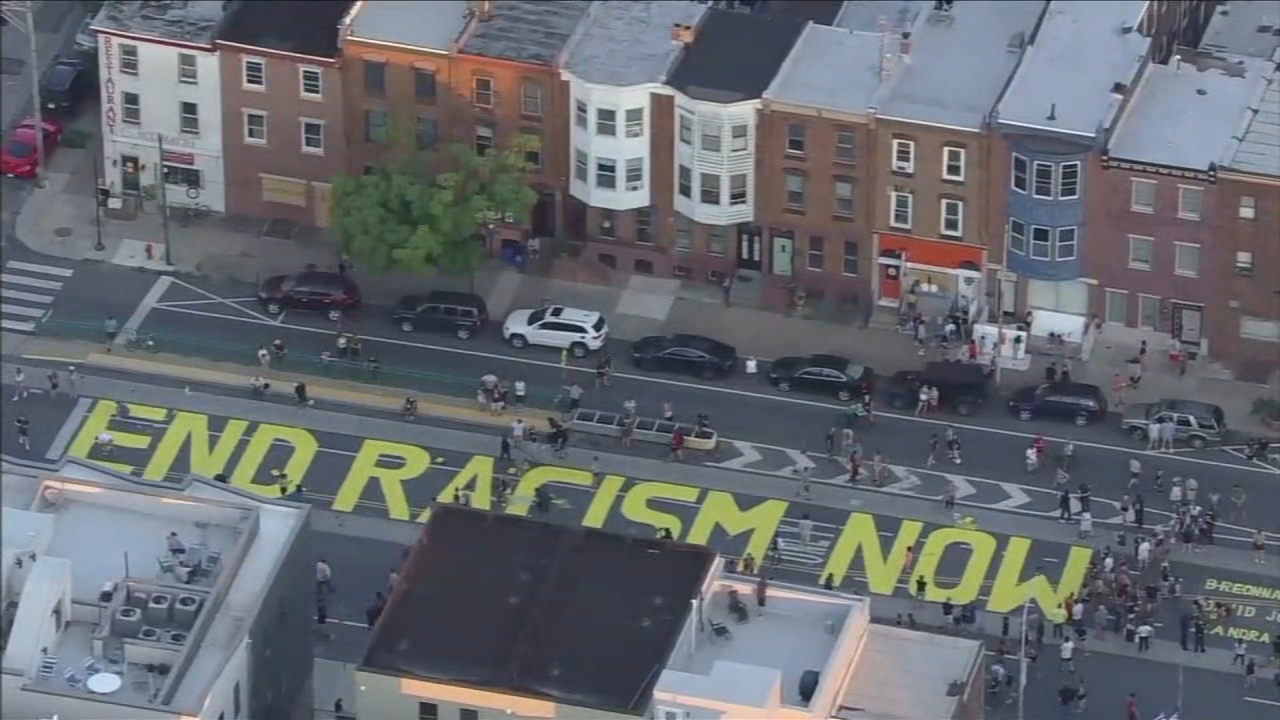 Protesters paint 'END RACISM NOW' outside Philadelphia police's 26th District Headquarters