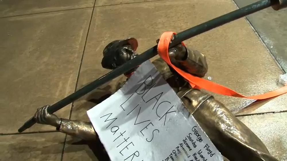 Demonstrators topple 2 statues from Confederate monument outside NC Capitol building