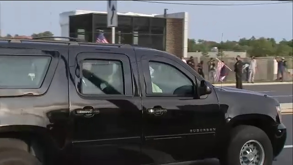 President Trump seen waving, wearing mask while driving by supporters outside hospital