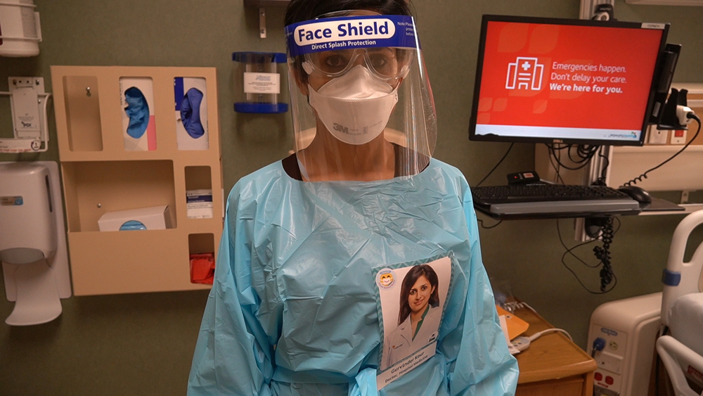 Masked doctors wear portraits to connect with patients