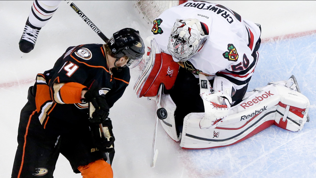 Chicago Blackhawks goalie Corey Crawford, right, blocks shot by Anaheim Ducks left wing Tomas Fleischmann in Game 5 of the Western Conf. final of the NHL playoffs on May 25, 2015.