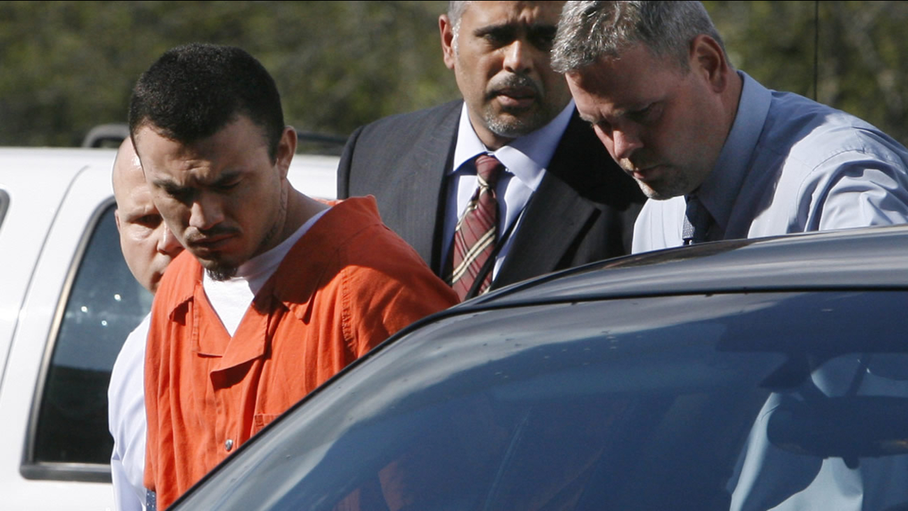 Ingmar Guandique, 27, left, who is accused of killing Chandra Levy, is escorted into the Violent Crimes Unit by detectives in Washington, on Wednesday, April 22, 2009.