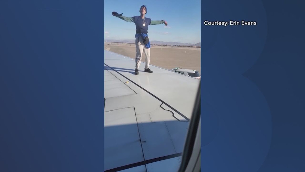 Man climbs onto plane wing before takeoff