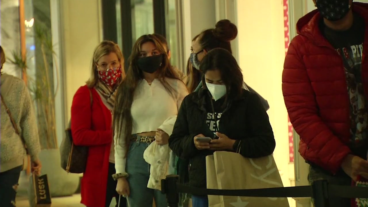 Holiday shoppers brave lines as stores implement COVID-19 rules